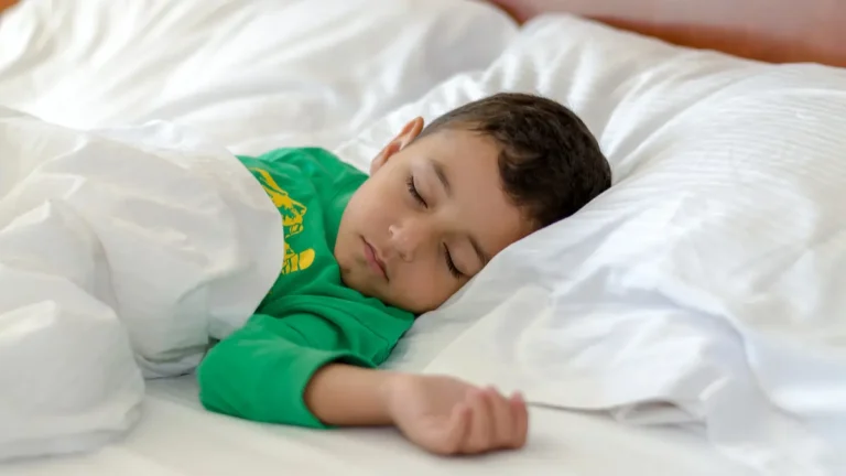 a boy sleeping in a bed